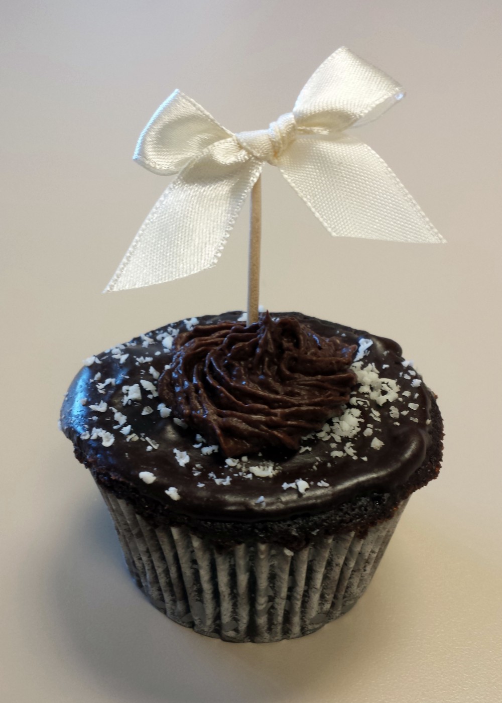 Chocolate Cupcake with a small ribbon on top, tied in a bow.